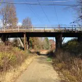 photo of a trail going under a bridge