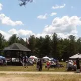 wide shot of market tents and people