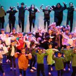 stage full of kids of all ages in costume