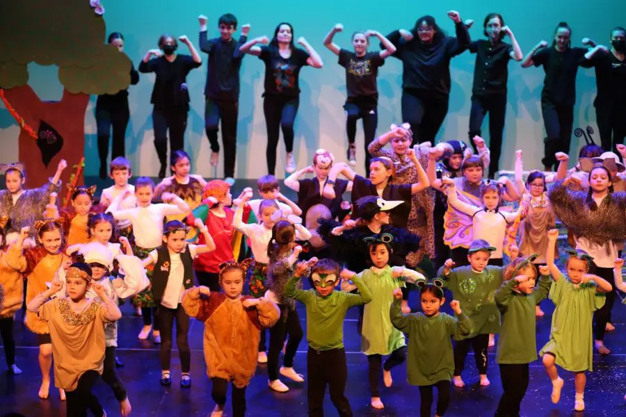 stage full of kids of all ages in costume