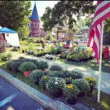 market with gardens in foreground and historic buildings in background