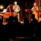 live band playing to a silhouette of an audience