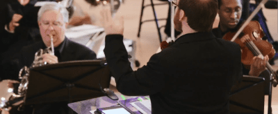 closeup of conductor leading orchestra