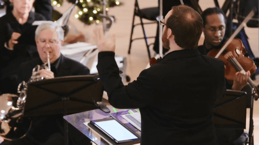 closeup of conductor leading orchestra