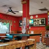 inside of pizza restaurant with red diner style decor