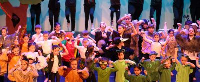 stage full of kids of all ages in costume